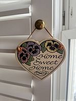 Front view of ceramic heart plaque showing pansy design and Home Sweet Home text