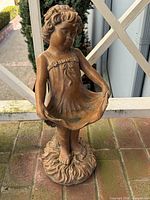 Full view of statue front, showing girl and base