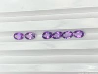 Six oval amethysts arranged horizontally