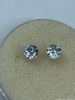 front view of both aquamarine stud earrings in display pad