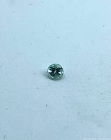 Top view of round alexandrite on white background