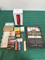 Overview of all candles, matchbooks, matchboxes and loose matches on green surface