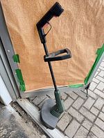 Full view of Black & Decker corded edger/string trimmer standing upright