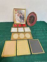 All seven brass-tone metal frames displayed to show variety of sizes and shapes