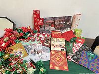 Table with bows, gift bags, boxes, tags and wrapping paper