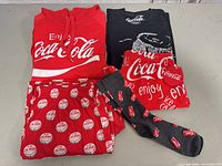 All five Coca-Cola clothing items laid out