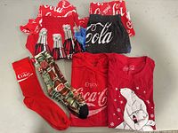 All eight Coca-Cola apparel pieces laid out