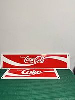 Both Coca-Cola signs front view