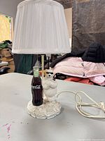 Full view of lamp with shade showing polar bear base and Coca-Cola bottle.