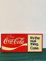 Front view of rectangular Coca-Cola lighted sign showing graphics and frame
