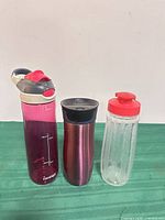 Three drinkware items standing upright