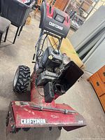 Full front-side view of Craftsman snow blower showing housing, engine, handles, wheels