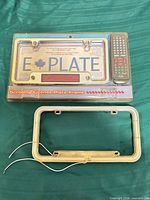 Front view showing sealed ePlate LED frame with remote, plus separate loose frame
