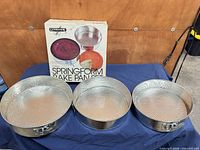 Box and three springform pans displayed