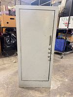 Full view of gray steel storage cabinet front showing door, handle, and lock fittings