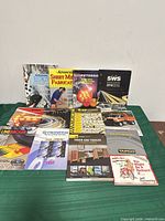 All twelve catalogs and books laid out for overview