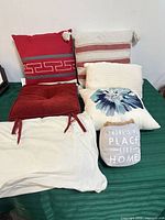 Group shot showing six of the seven textile items on green surface