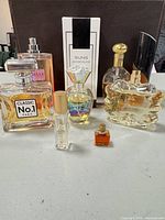 Group shot of all seven perfume bottles including box