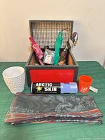 All items grouped: umbrellas in storage chest, planter, cooling towel, mini bucket, folded scarf