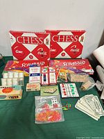 Overall view showing Coca-Cola Chess, Scrabble, poker chips, cards, dice, tokens