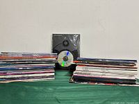 Two stacks of assorted magazines with sealed B&W booklet and DVD centred