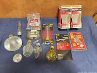 Overview of packaged and loose bulbs including Sylvania twin-pack, Globe and Philips capsules, Malibu pack and assorted loose bulbs