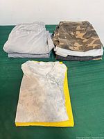 Stack of folded shorts and T-shirts showing colours and styles