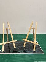 Front view of both wooden easels standing on tray