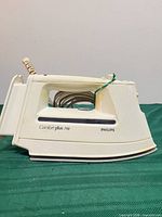 Side profile showing Philips branding, Comfort plus 710 model text, handle and coiled cord