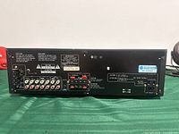 Rear panel with RCA inputs/outputs, speaker terminals, power specs label