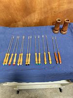 Forks and holders laid out on cloth showing full length and colors