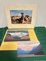 All three prints displayed; matted print upright, two loose prints flat