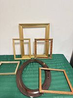 Group of six assorted wood frames showing sizes, shapes and finishes