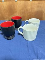 Set of four mugs showing all patterns and colors