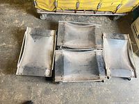 Top view of four metal wheel dollies