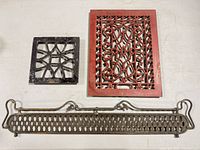 Three pieces: square black grate, red rectangular vent, long narrow brass-tone panel