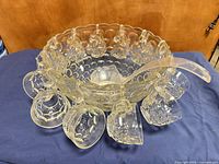 Punch bowl with cups hanging and ladle inside