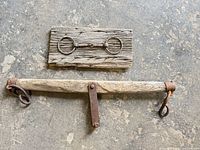 Both items: ox yoke below, plank with horse bit above, showing overall condition and size relation