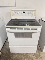 Front view of Whirlpool slide-in range showing cooktop, control panel, drawer