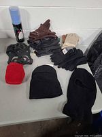 all items laid on table showing hats gloves cleats towel