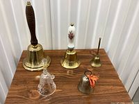 Group shot of all five bells on tabletop