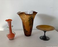 Front view of three decorative glass pieces
