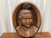 Front view showing full carved portrait and oval frame