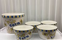 Front view of large bowl and three small bowls showing graphics and rim design