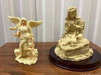 Both resin sculptures side by side on table