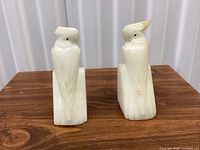 front view of both alabaster parrot bookends
