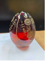 Front view showing ruby glass egg with gold gilt floral design