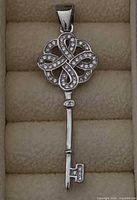 Front view of sterling silver key pendant showing CZ stone placement and overall design