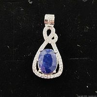 Front view of sterling silver teardrop pendant with sapphire and CZ accents