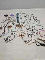 Overview of all fabric and ribbon necklaces and bracelets spread on table